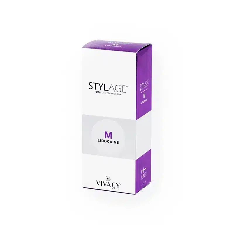 The image shows a box of STYLAGE® M with Lidocaine. The packaging is primarily white with purple accents at the top and bottom. The text and logo are visible on the front of the box.