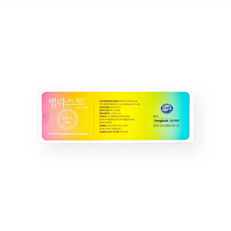 A rectangular medical patch package with a gradient background from yellow to blue. The text is mainly in Korean, featuring product information and branding. The label includes seals of certification and the manufacturer's name "Dongkook" and the product name BELLAST® SOFT L.