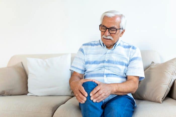 A senior male feeling the effects of chronic pain caused by knee osteoarthritis.