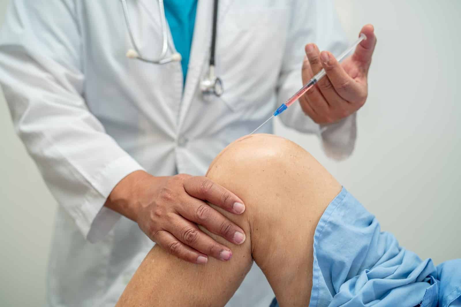 Expert carefully and strategically inserting Orthovisc injection in the knee joint.