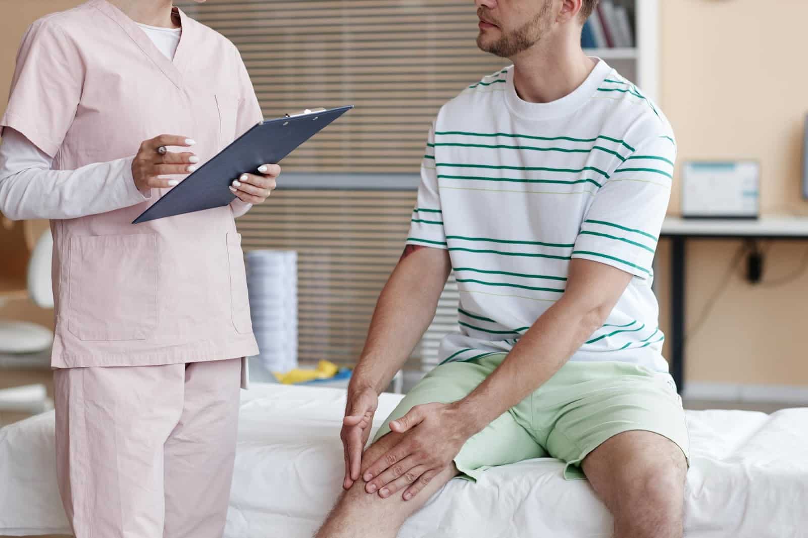 Patient speaking with specialist after experiencing pain in his knee joint.