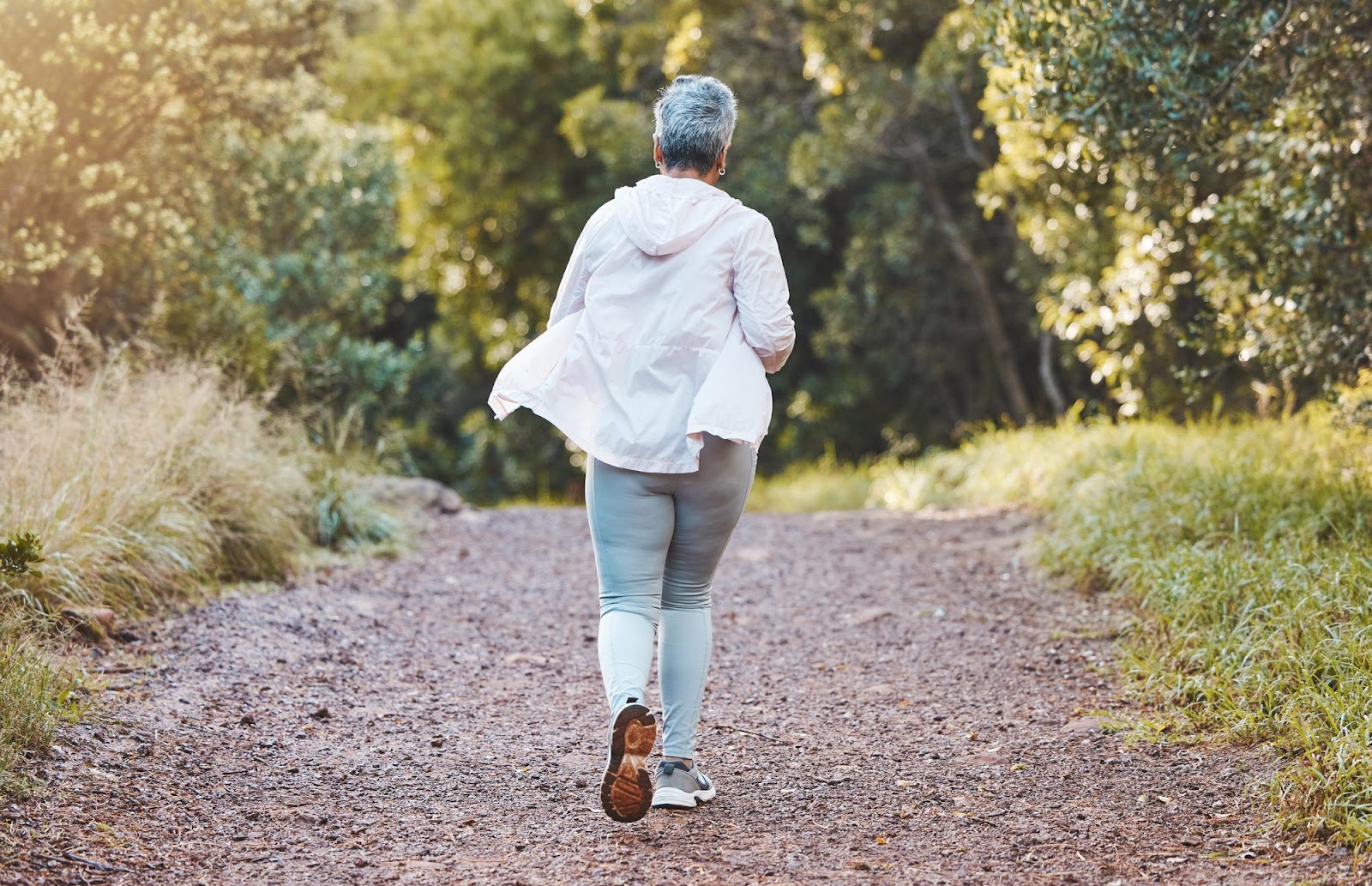 A woman going for a jog without feeling knee pain.