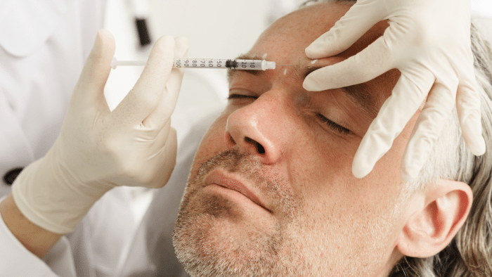 Older male patient getting Botox.