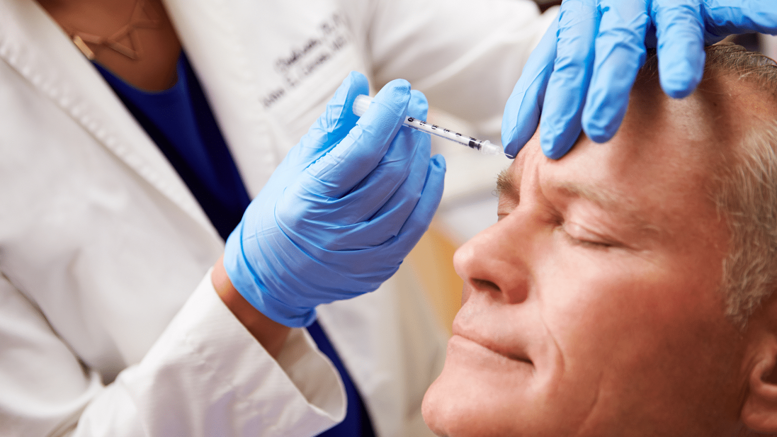 Male patient in his 60s receiving Botox treatment.
