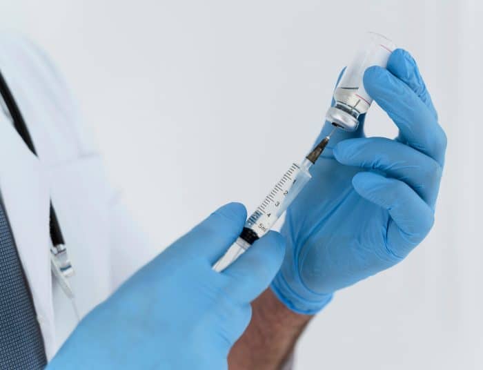 A healthcare professional carefully prepares Dysport injection before treatment.