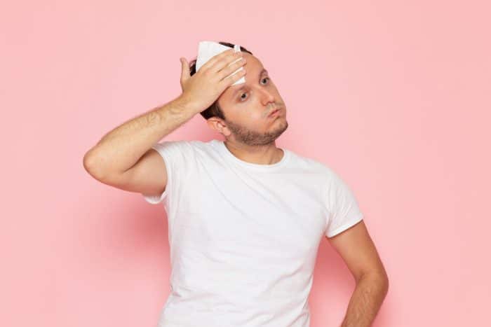 A male individual feels uncomfortable because of excessive sweating.