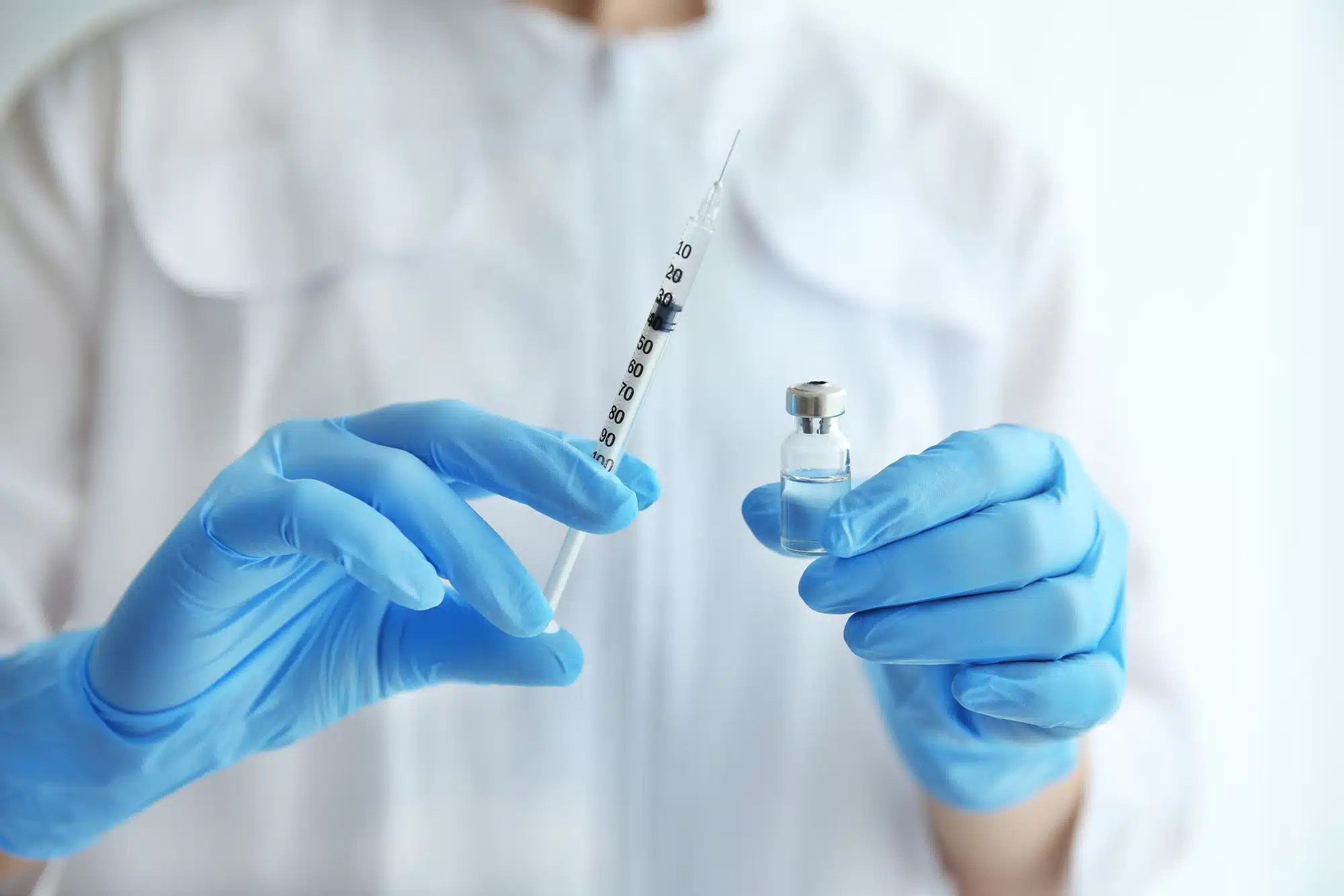 close up of a medical professional holding suringe