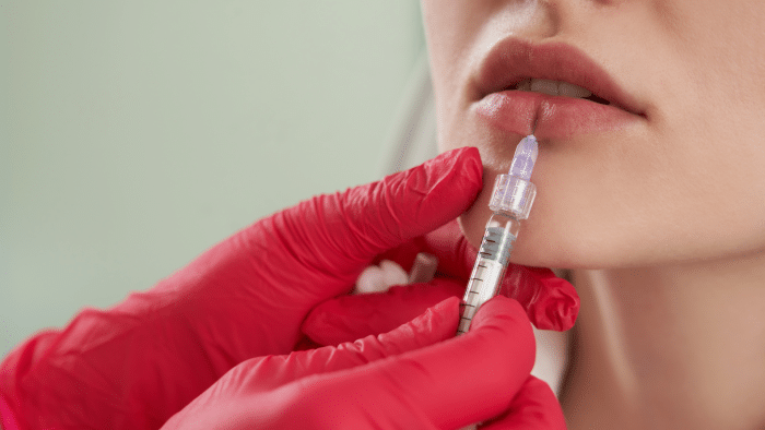 Woman getting lip treatment. 