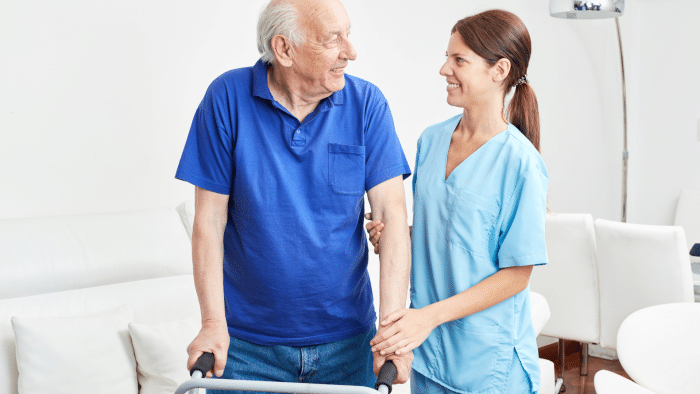 A man in his seniors getting physical treatment to make knees less painful.