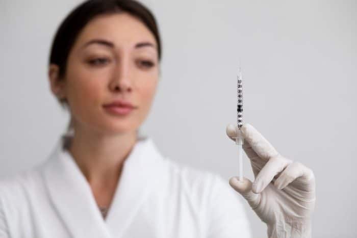 A healthcare professional holding Dysport injection.
