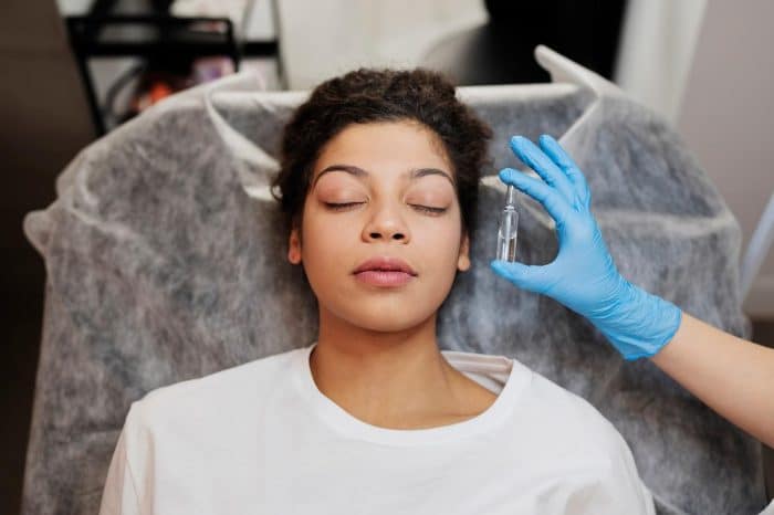 A healthcare professional assesses the appropriate treatment plan for a patient wanting facial rejuvenation.