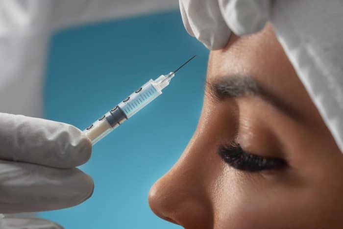 A patient receives neurotoxin injection to treat forehead lines.
