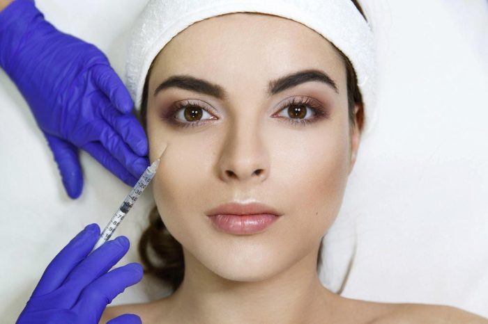 A woman receiving neurotoxin injection in a clinical setting.