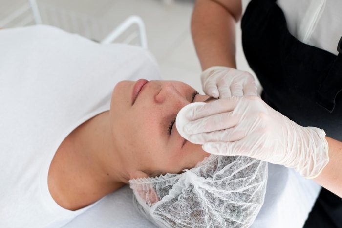 A healthcare professional preps the injection site for neurotoxin treatment that will address unwanted wrinkles.
