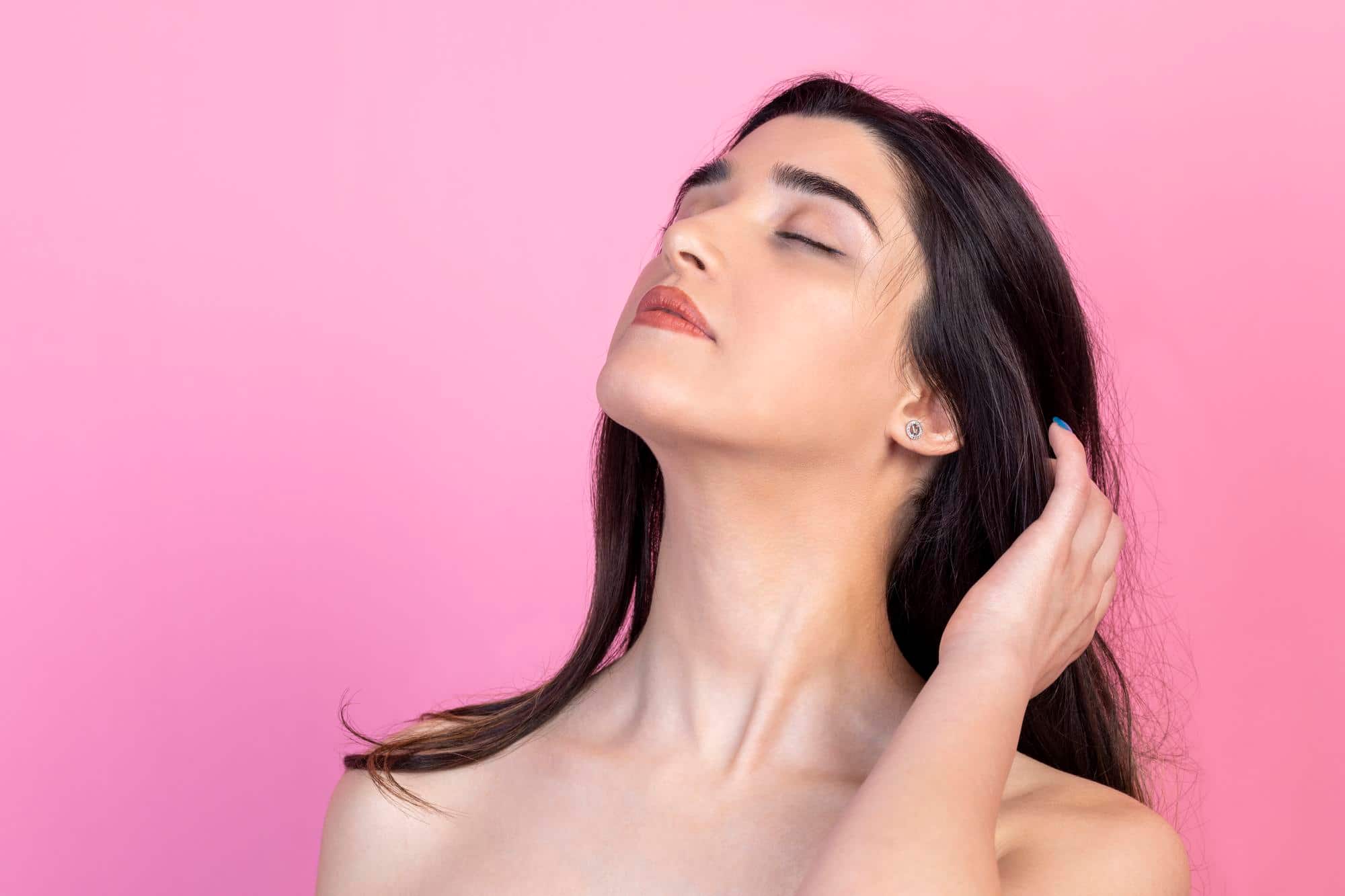 A woman shows off her defined and well-structured jawline.