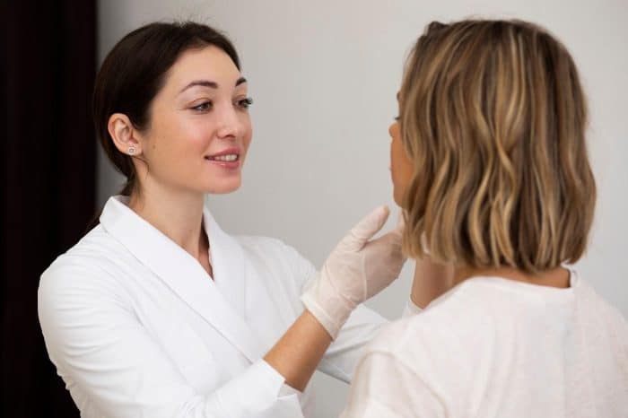 A healthcare professional assessing the facial anatomy of a patient interested in getting Dysport.