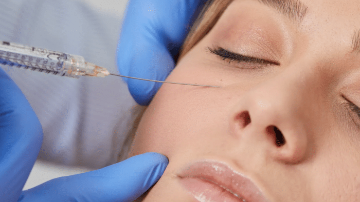 Woman getting eye injection. 