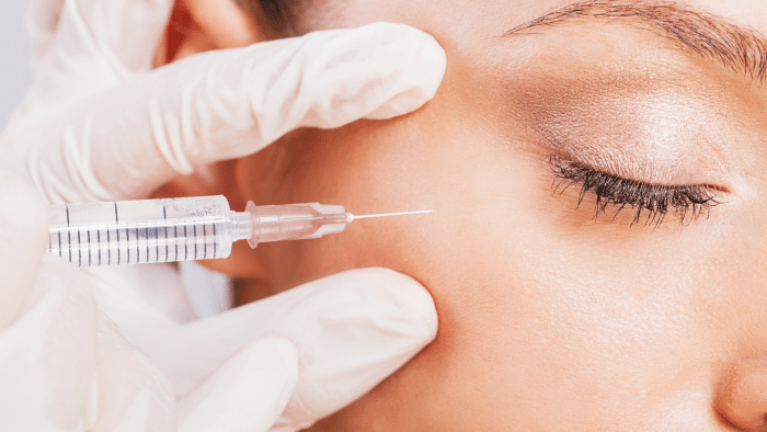 Woman getting eye injection. 