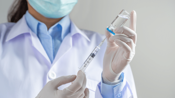 Doctor injecting.