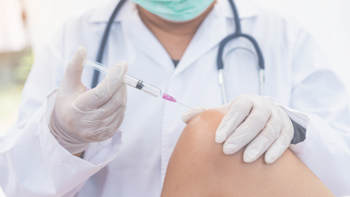 Doctor injecting.