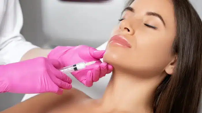 Woman getting facial injection.