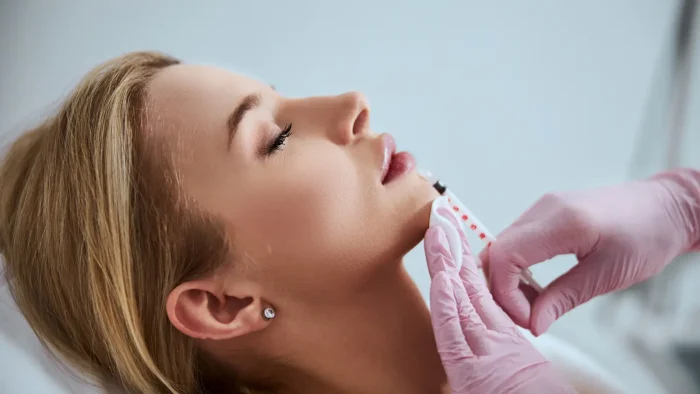Woman getting facial injection. 