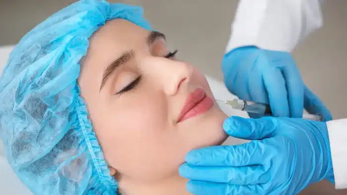 Woman getting her face injected. 