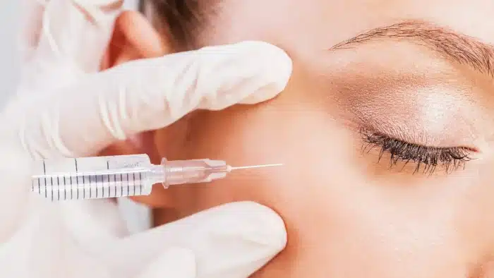 Woman getting her face injected. 