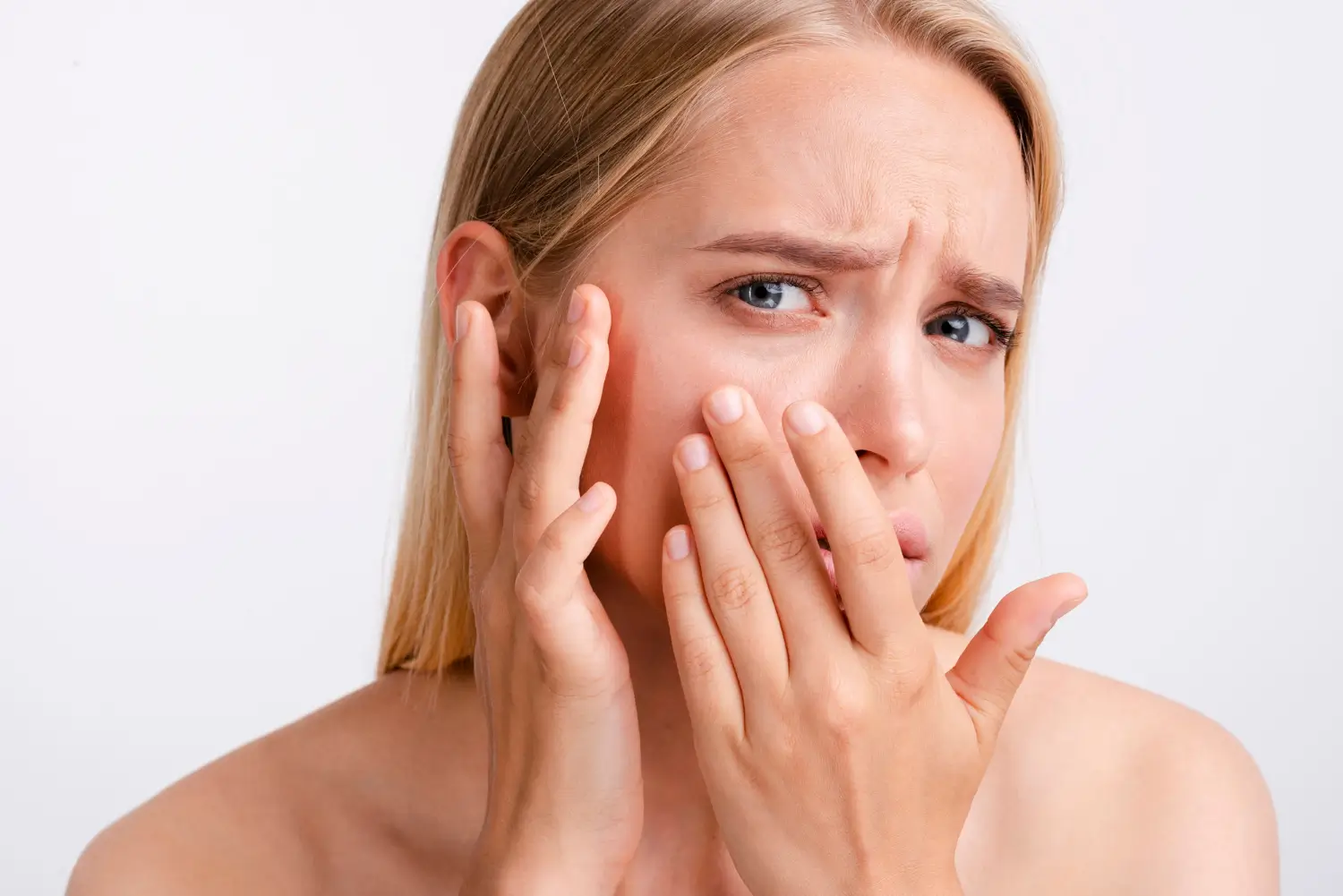 Woman feeling tenderness in her face.