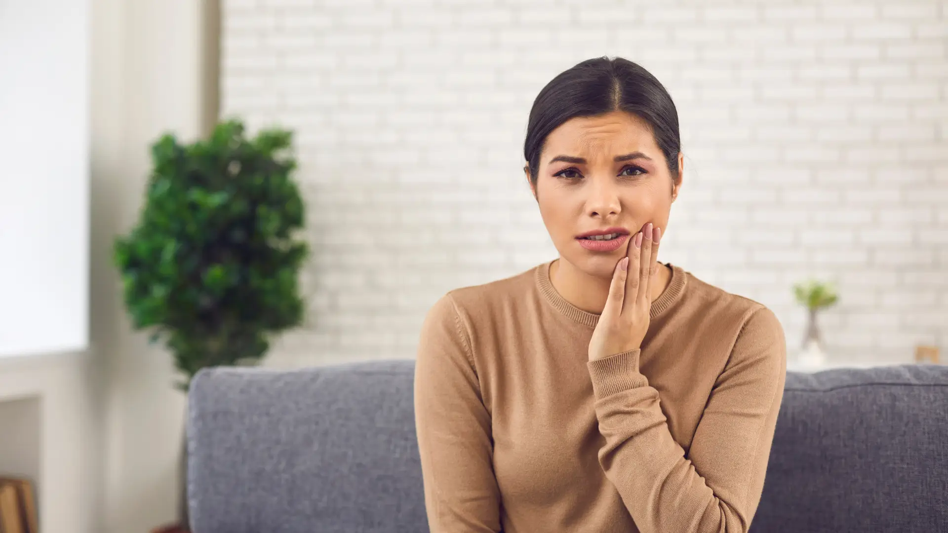 A woman feeling tenderness and discomfort following skin booster injection