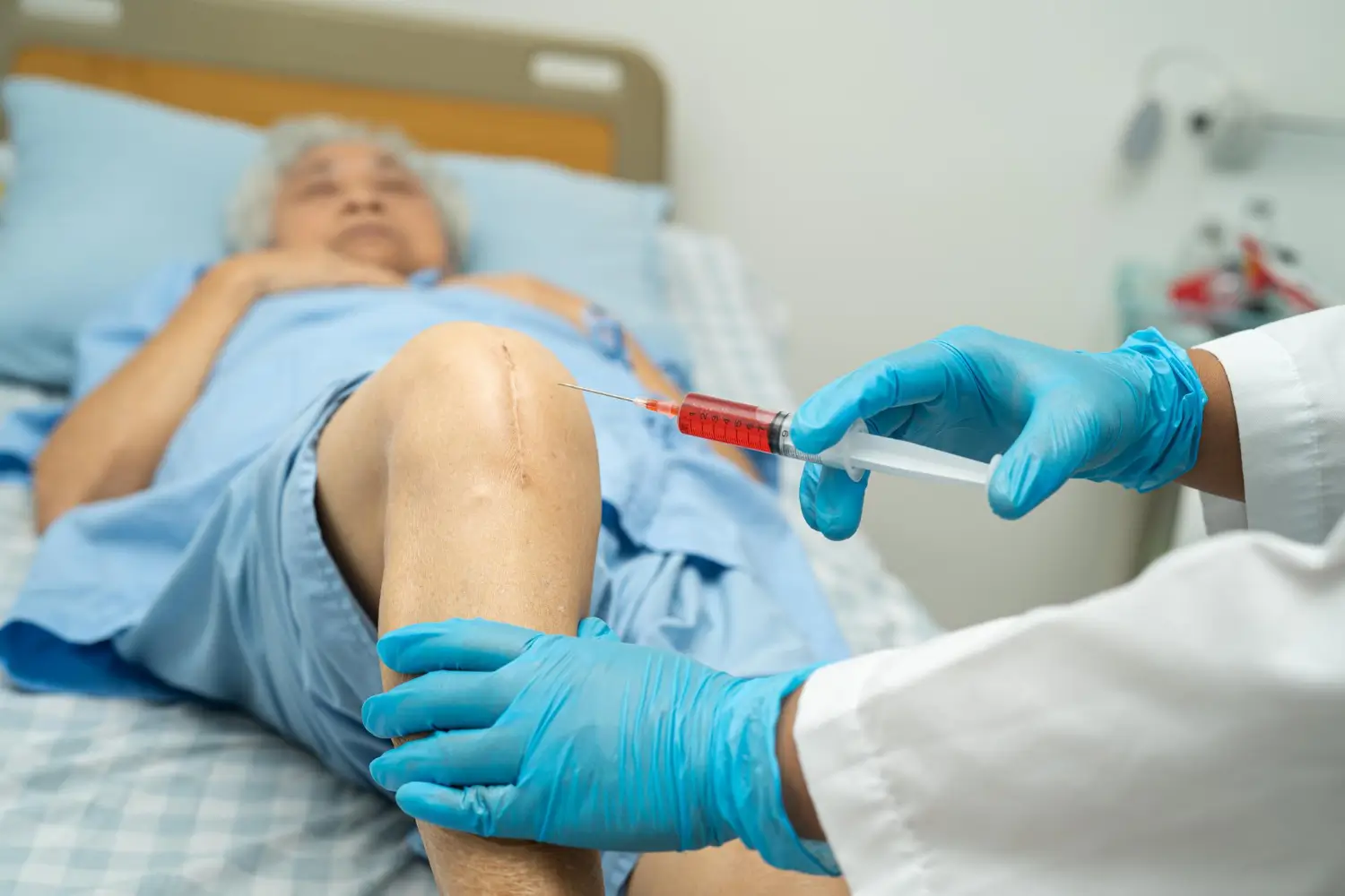 Person getting knee injection.