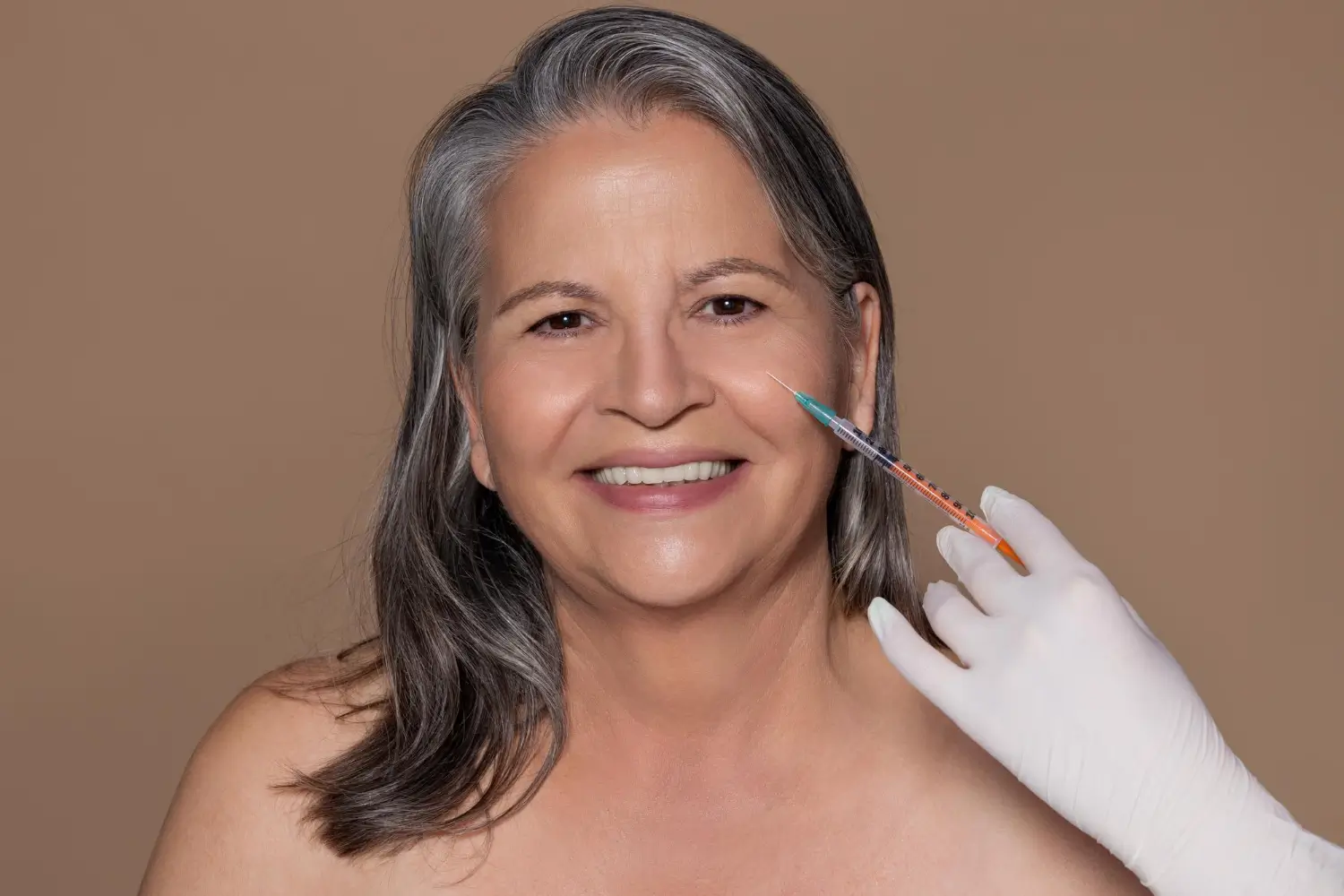 Woman receiving filler injection for skin rejuvenation.