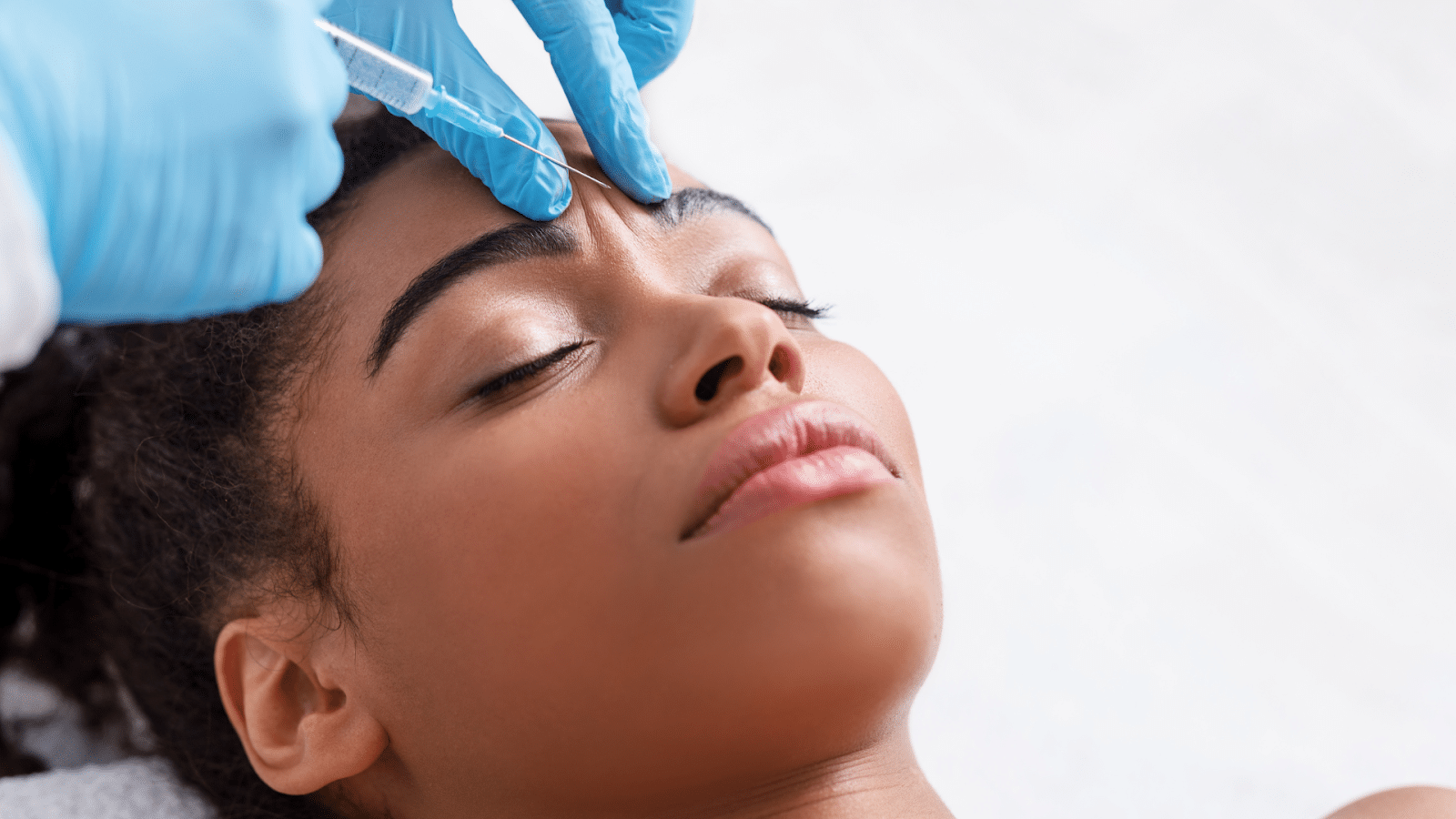 Woman getting a facial injection.