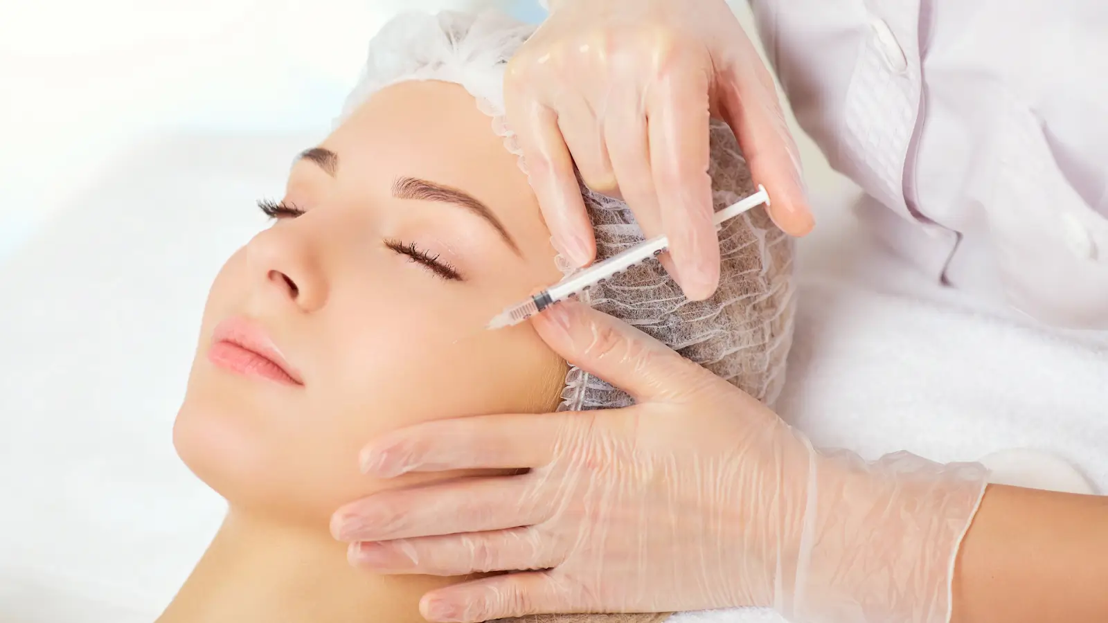 Woman getting a facial injection. 