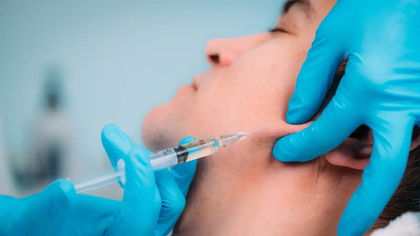 Injecting filler in the face.