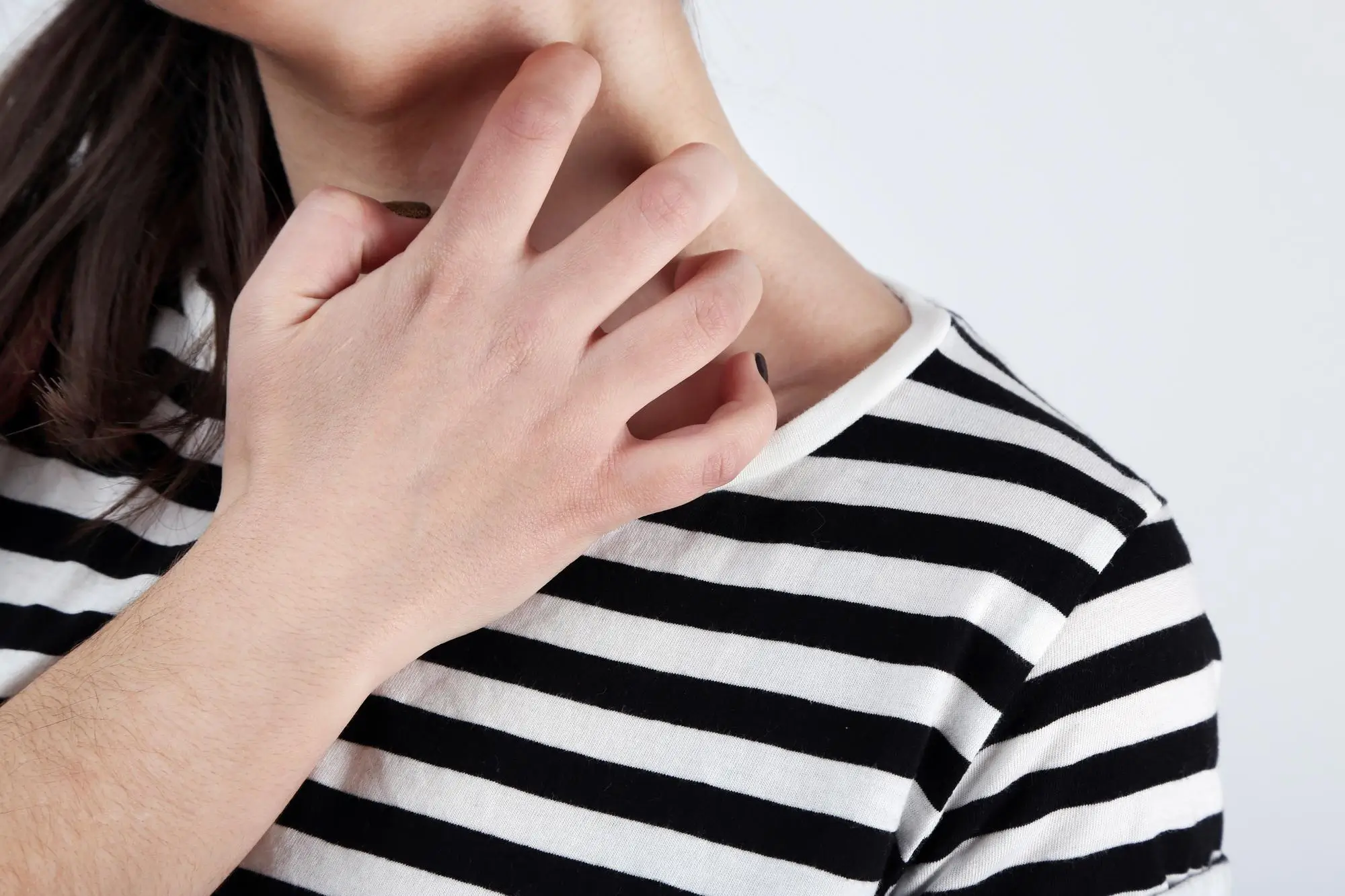 Scratching on neck.