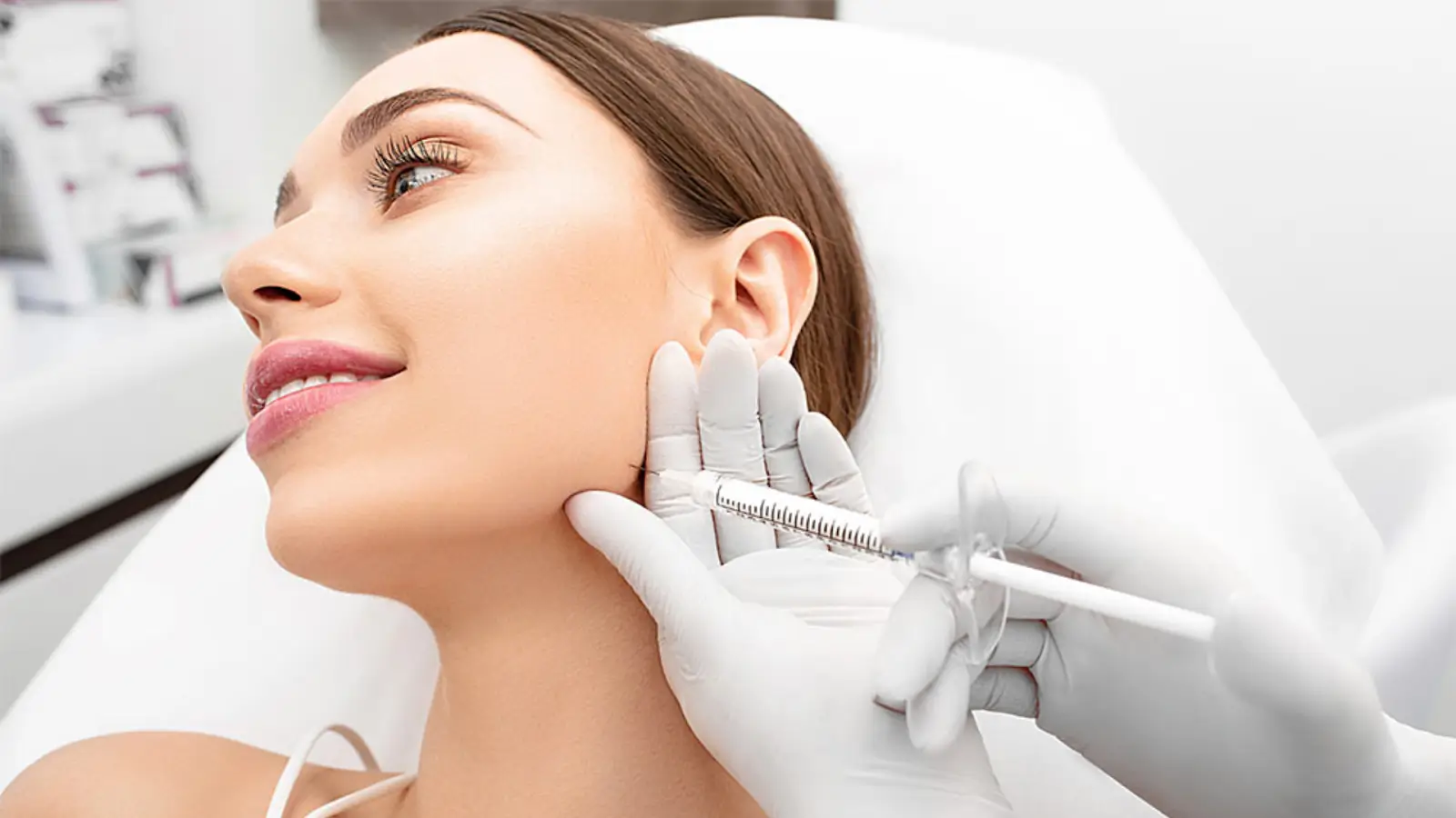 A woman receives filler in the jawline.