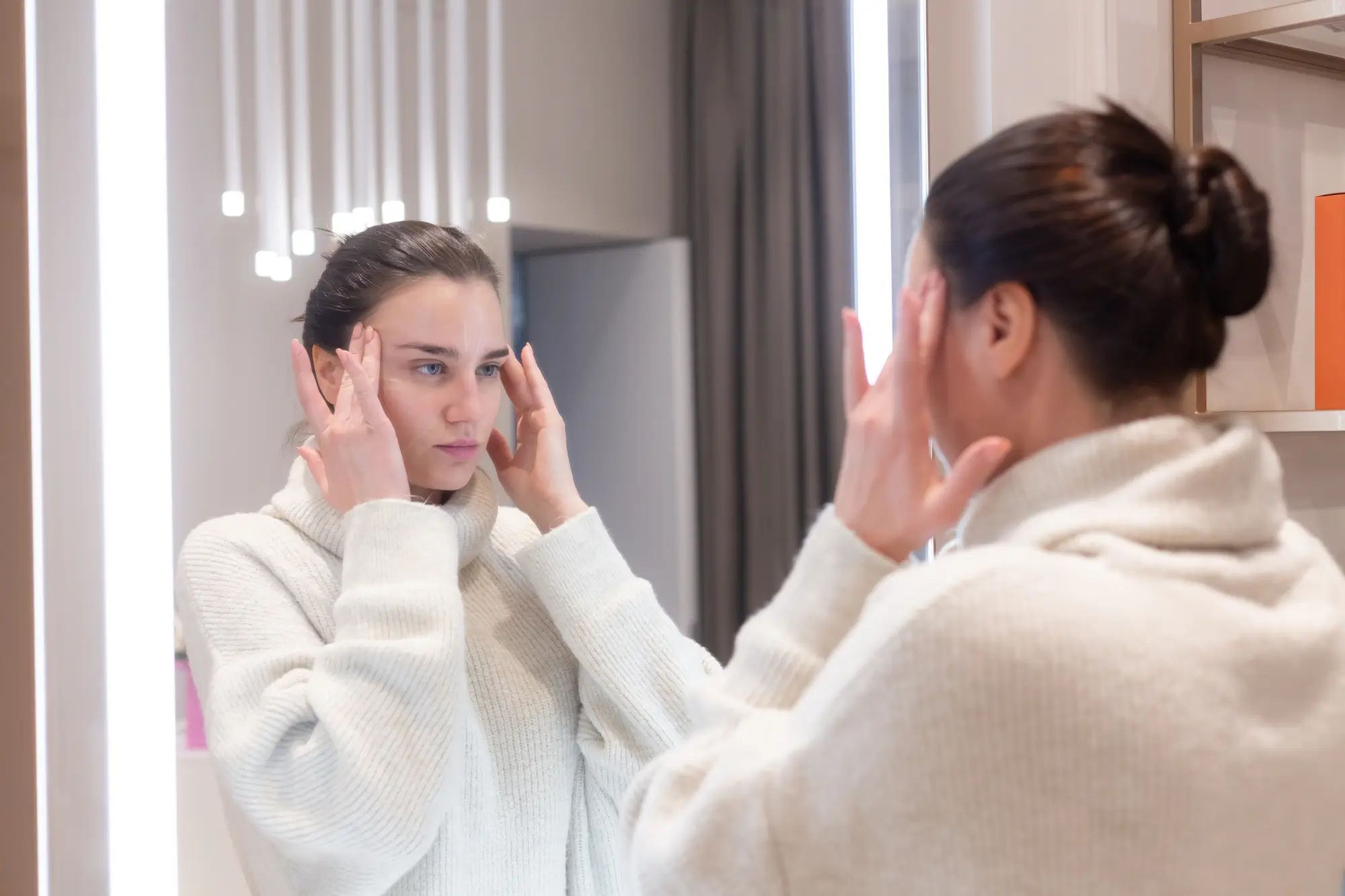 Woman looking into the mirror. 
