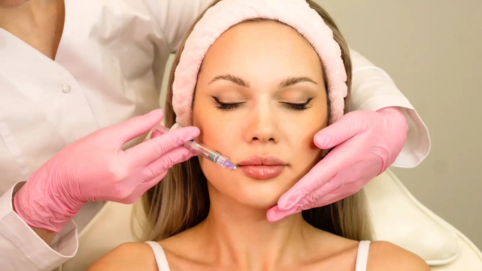 A doctor skillfully injects filler