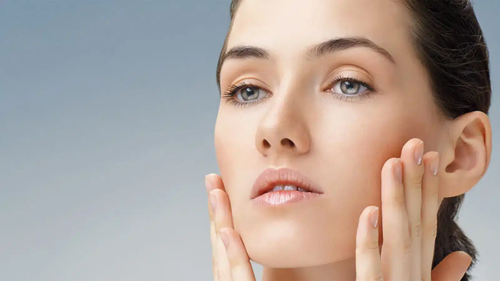 Woman holding her face.