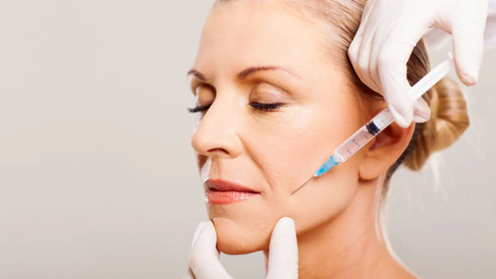 Woman receives injection for facial enhancements.