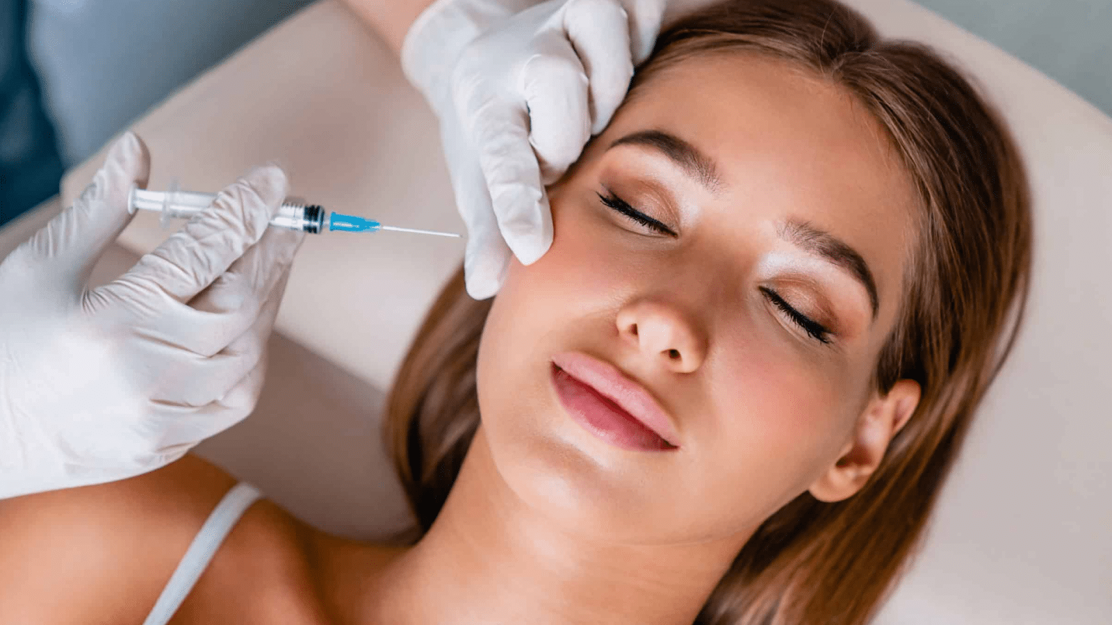 Woman getting facial injection.