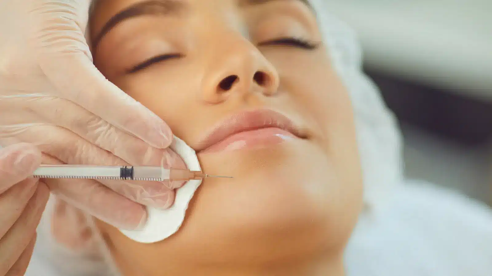 Woman getting face injected.