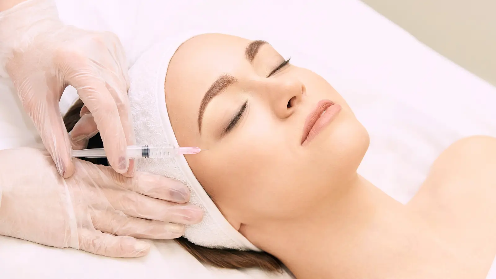 Woman getting face injected.