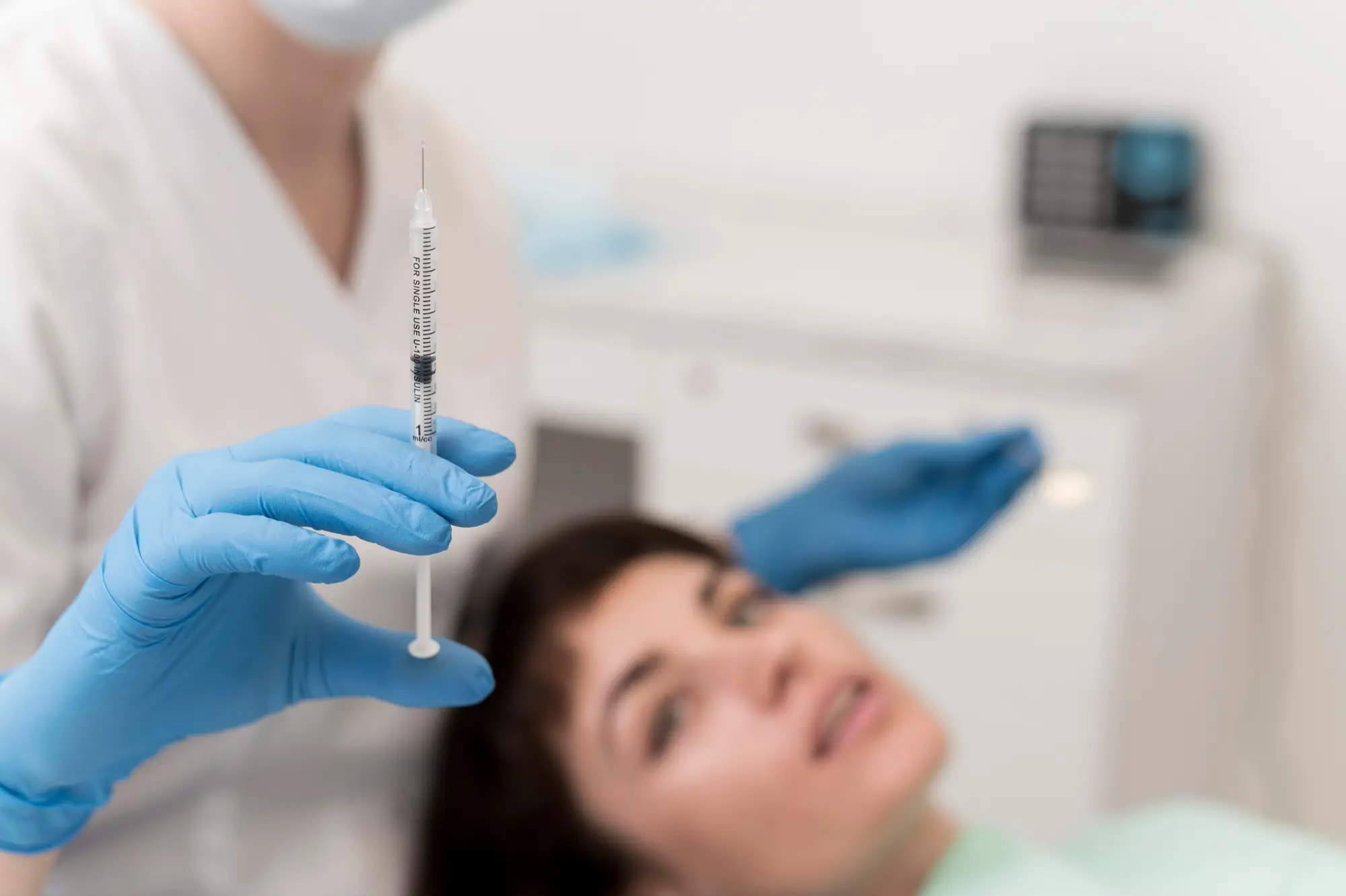 Doctor holding up syringe before procedure