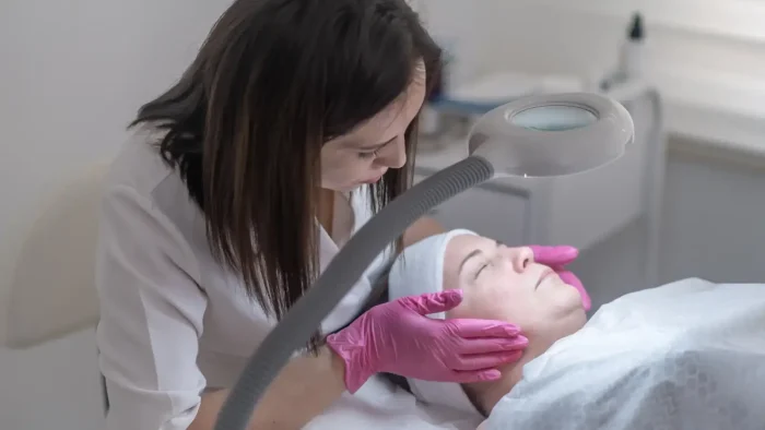 Woman getting face checked.