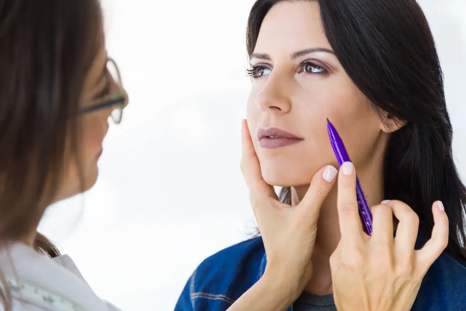 Doctor checking face.
