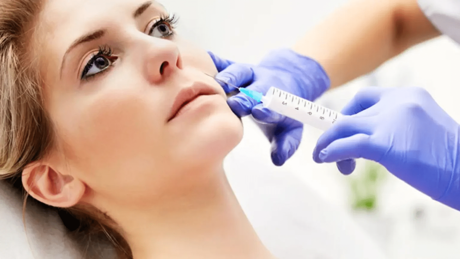 Woman getting facial injection.