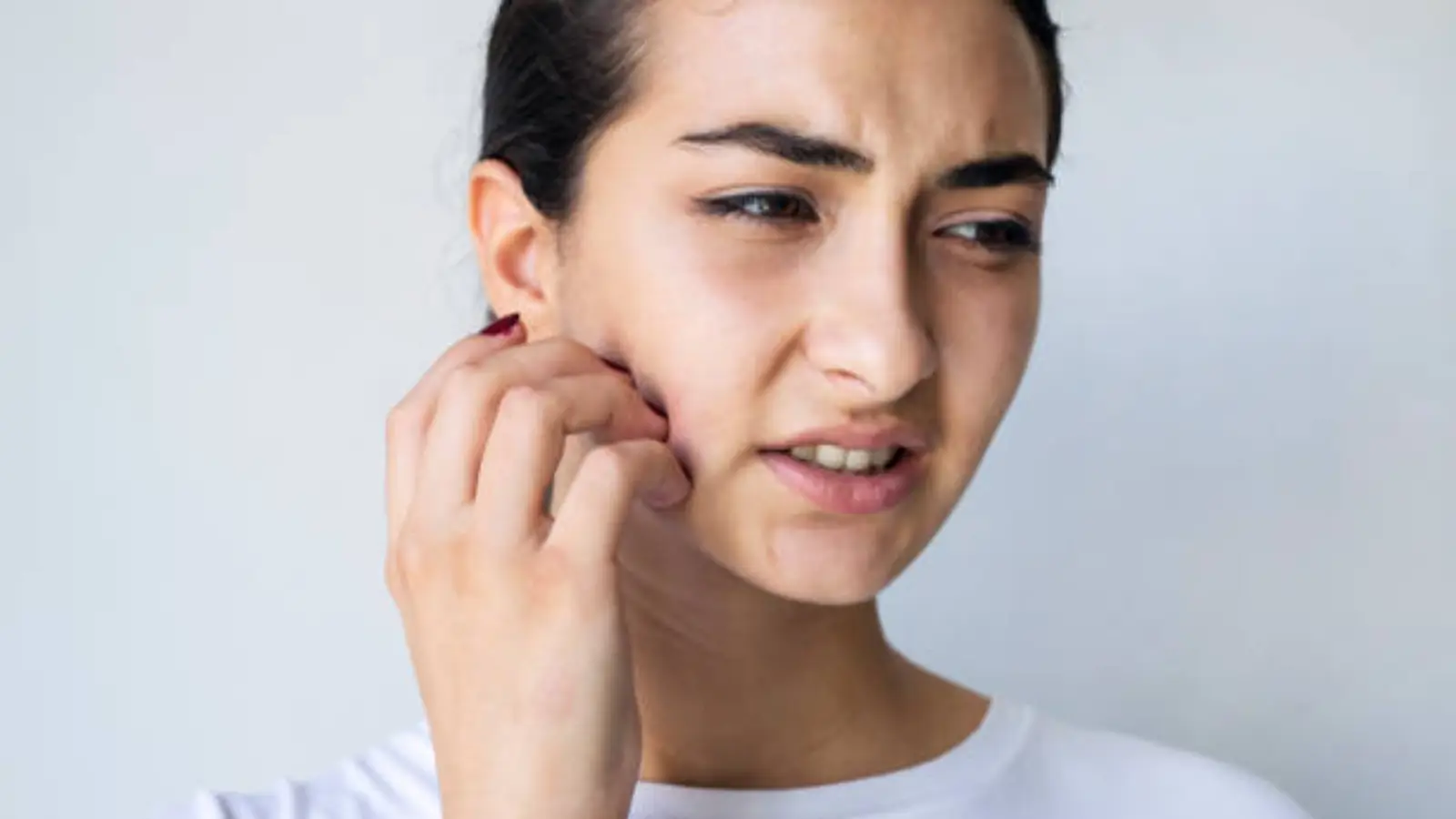 Woman scratching skin.