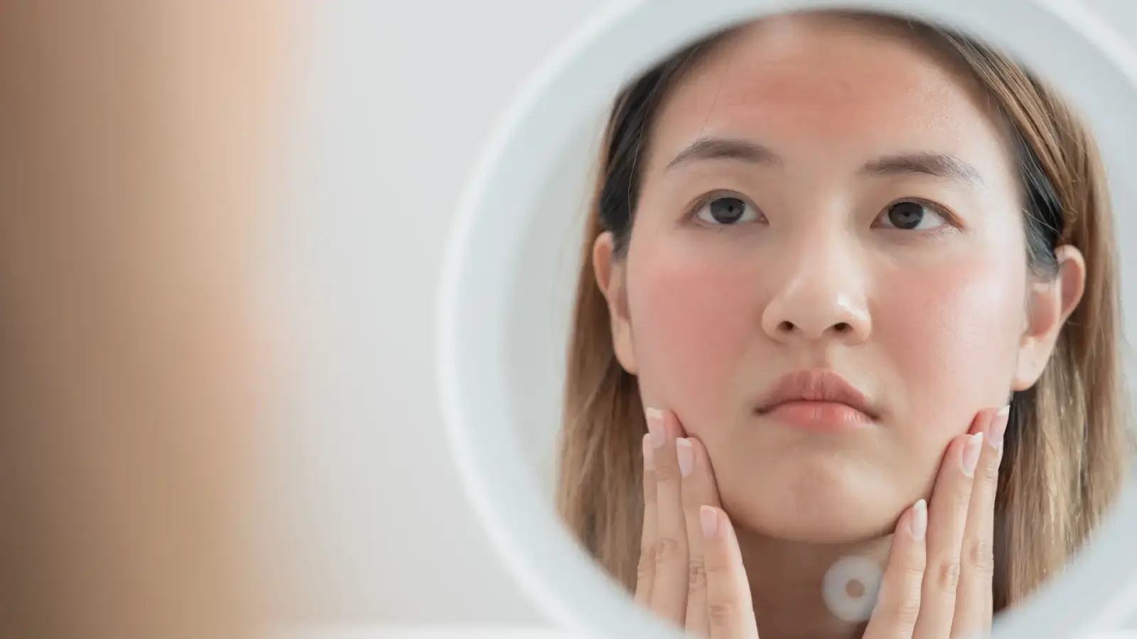 Woman looking into mirror.